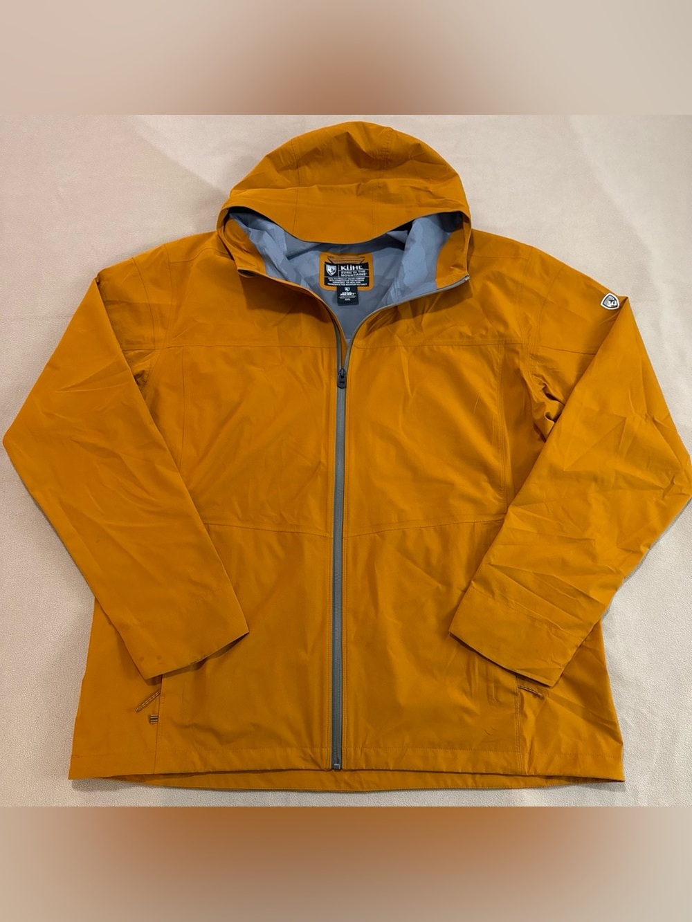 KÜHL Stretch Voyagr Jacket in mustard yellow with waterproof fabric and seams